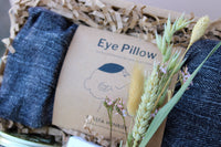 A close-up of Wild About Flowers' Lavender Relax Gift Box displays a boxed fabric eye pillow labeled "Eye Pillow" with a line drawing of its use; dried grasses and flowers decorate the packaging.