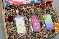 The Crackers about Gin Gift Box by Wild About Flowers meets your Christmas gifting needs with three exquisite bottles of gin from Chew Valley Distillery. It includes flavors like Pink Grapefruit & Rosemary, Clementine & Cranberry, and Apple & Blackberry, carefully arranged with decorative dried flowers and orange slices for an elegant touch.