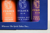 A close-up of the 6 O'Clock Gin Cocktails Gift Box from Wild About Flowers features three vibrant cans: Exotic Orange, London Dry Gin & Tonic, and Damson & Ginger. Ideal for any occasion, these ready-to-drink cocktails invite you to explore "Wherever The Spirit Takes You.