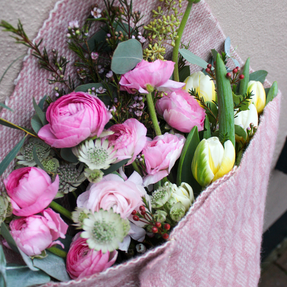 Send love with Wild About Flowers’ 'Armful of Love' Valentines wrap—pink and white ranunculus and tulips with lush greenery, beautifully wrapped in pink cloth. Perfect for fresh flower delivery this Valentine’s Day.