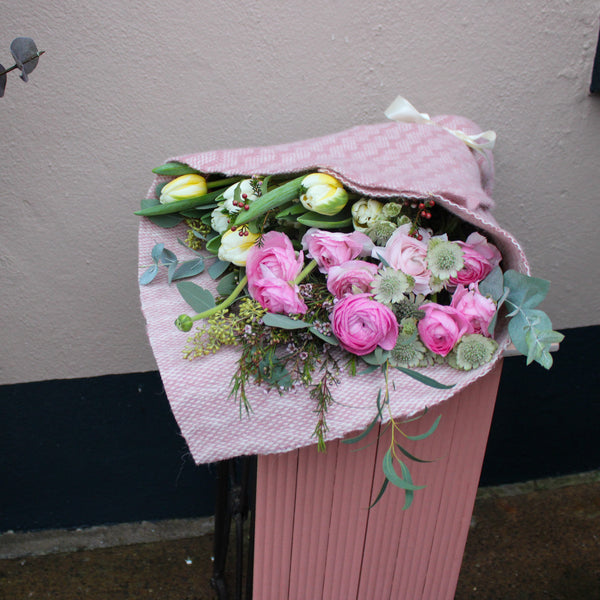 The 'Armful of Love' Valentines wrap by Wild About Flowers features pink and white roses and tulips in pink textured paper—an ideal romantic gift for fresh flower delivery.