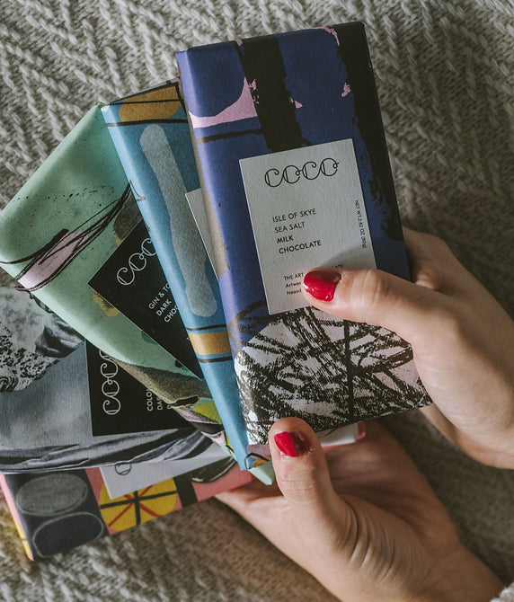 Hand holding colourful Coco chocolate bars, including Isle of Skye sea salt milk chocolate
